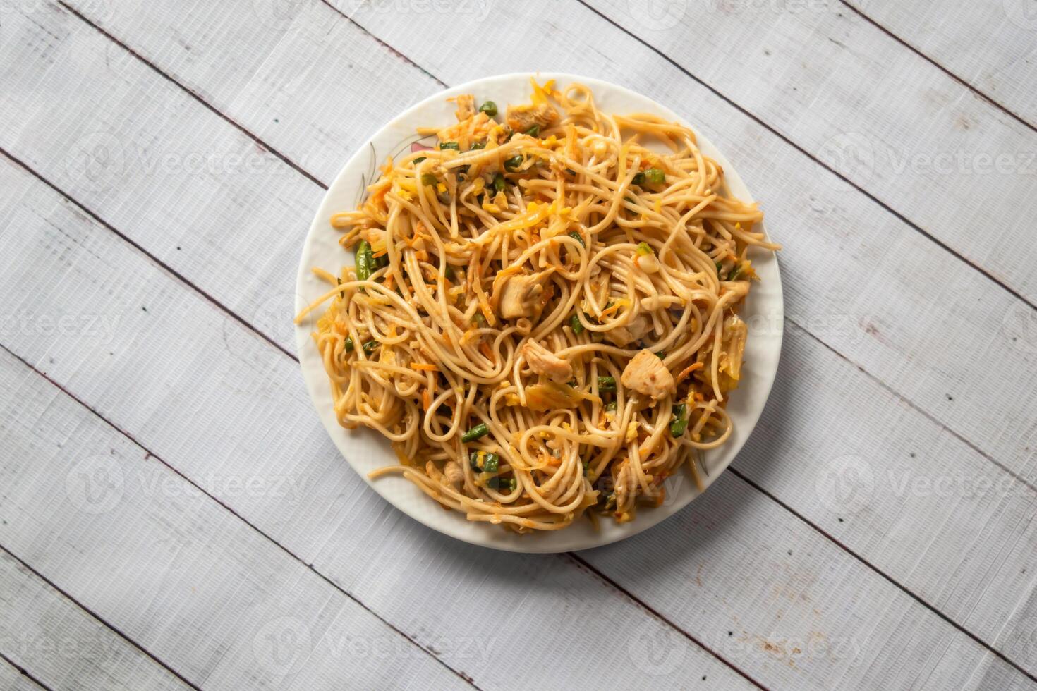 Chicken noodles served in dish isolated on napkin bangladeshi food top view on table photo