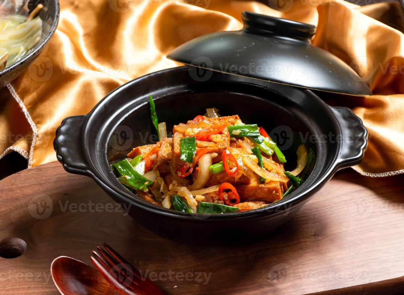 Lao Pi tender tofu with fork and spoon served in dish isolated on wooden board side view of asian food photo