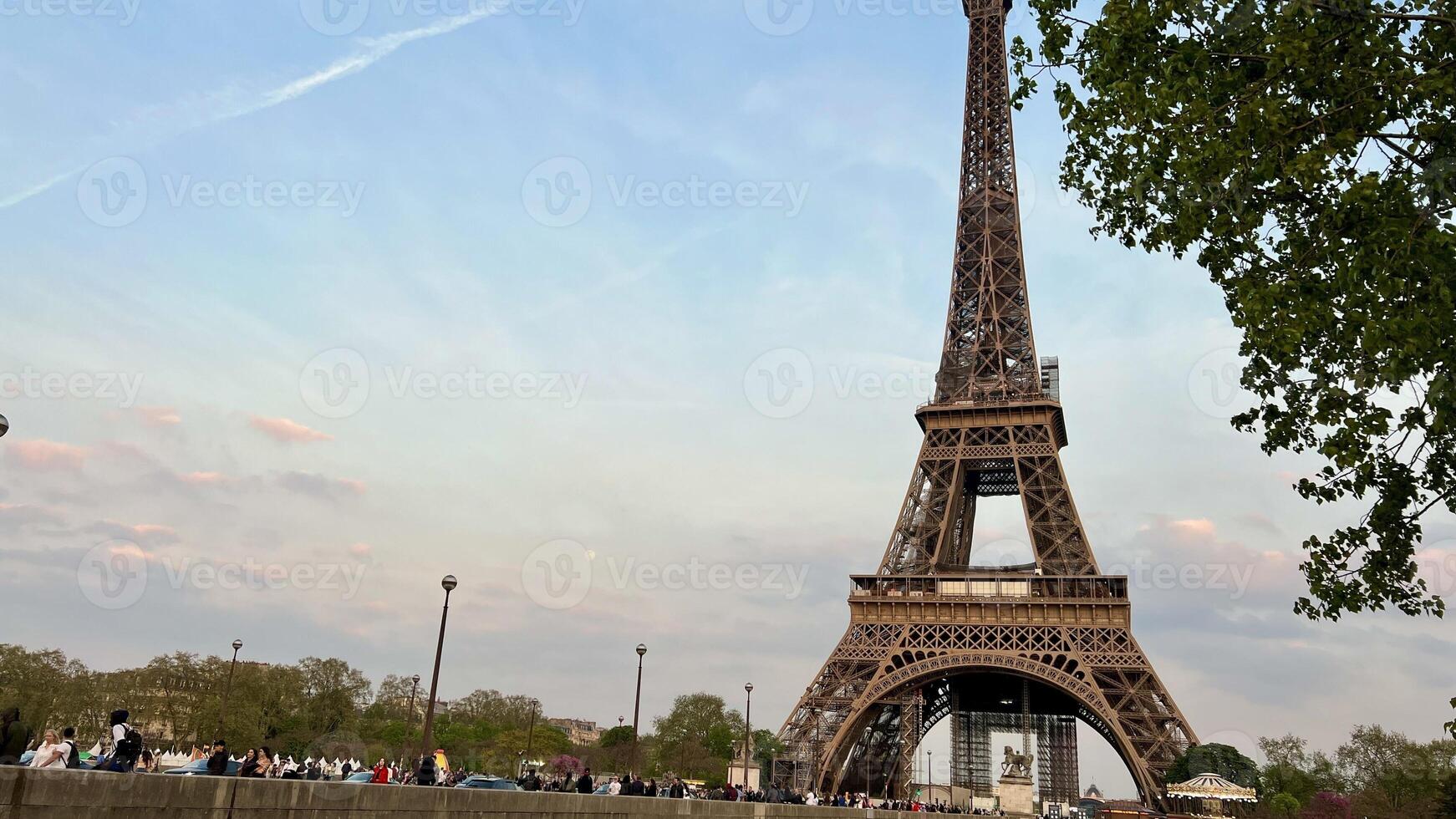 The Eifel Tower in the evening is a good screensaver for advertising a trip to Paris photo