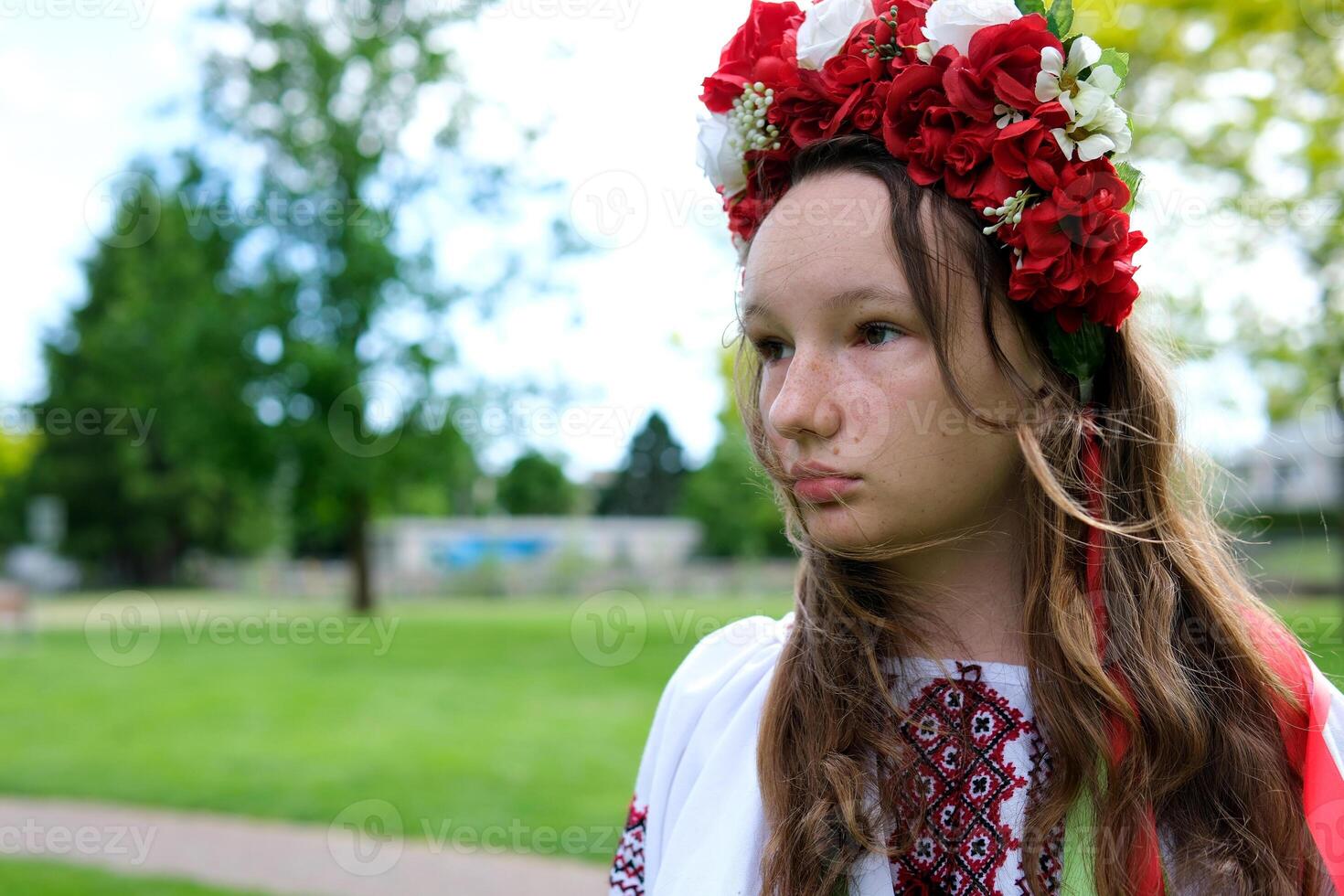 beautiful woman with a wreath on a green meadow ukrainian girl with a wreath of flowers photo