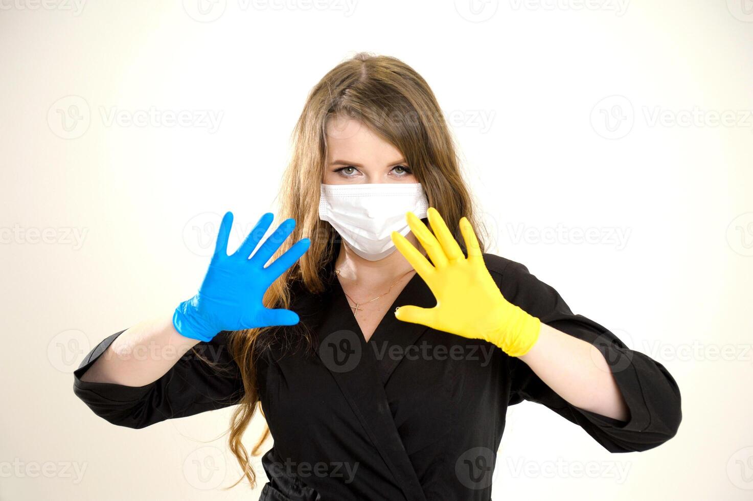 No war doctor holding hands with spread fingers yellow and blue gloves stop the war russian aggression ukraine will win victory of ukrainian people ukrainian flag in clothes white studio background photo