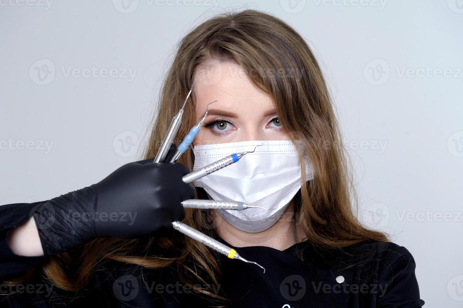 scaler and curette Dental clinic, private practice, the dentist uses binoculars for the best result and work, the process of removing tartar. photo