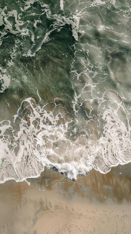 Aerial View of Ocean Waves and Sand photo