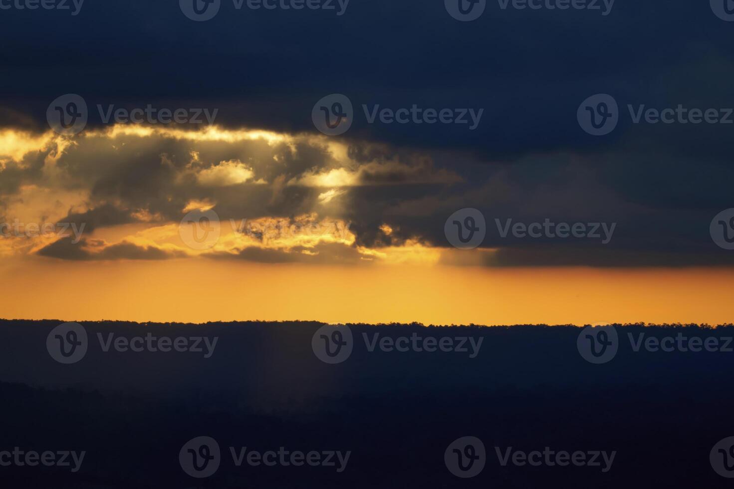 Golden Sunset Through Storm Clouds photo