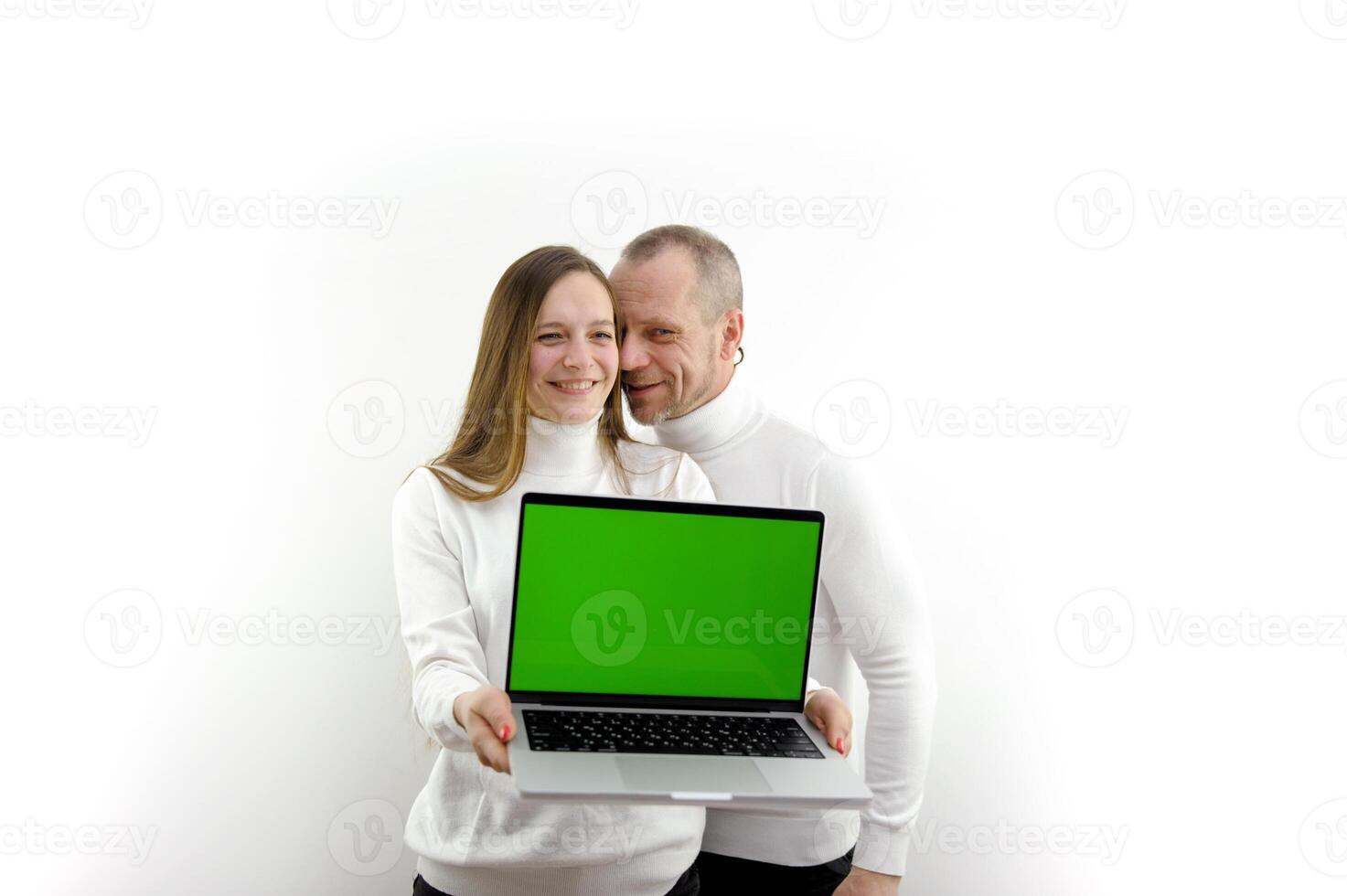 man and woman laptop with green screen chromakey happy satisfied advertises product online training man whispers something in ear online shopping white background place for text satisfied and happy photo
