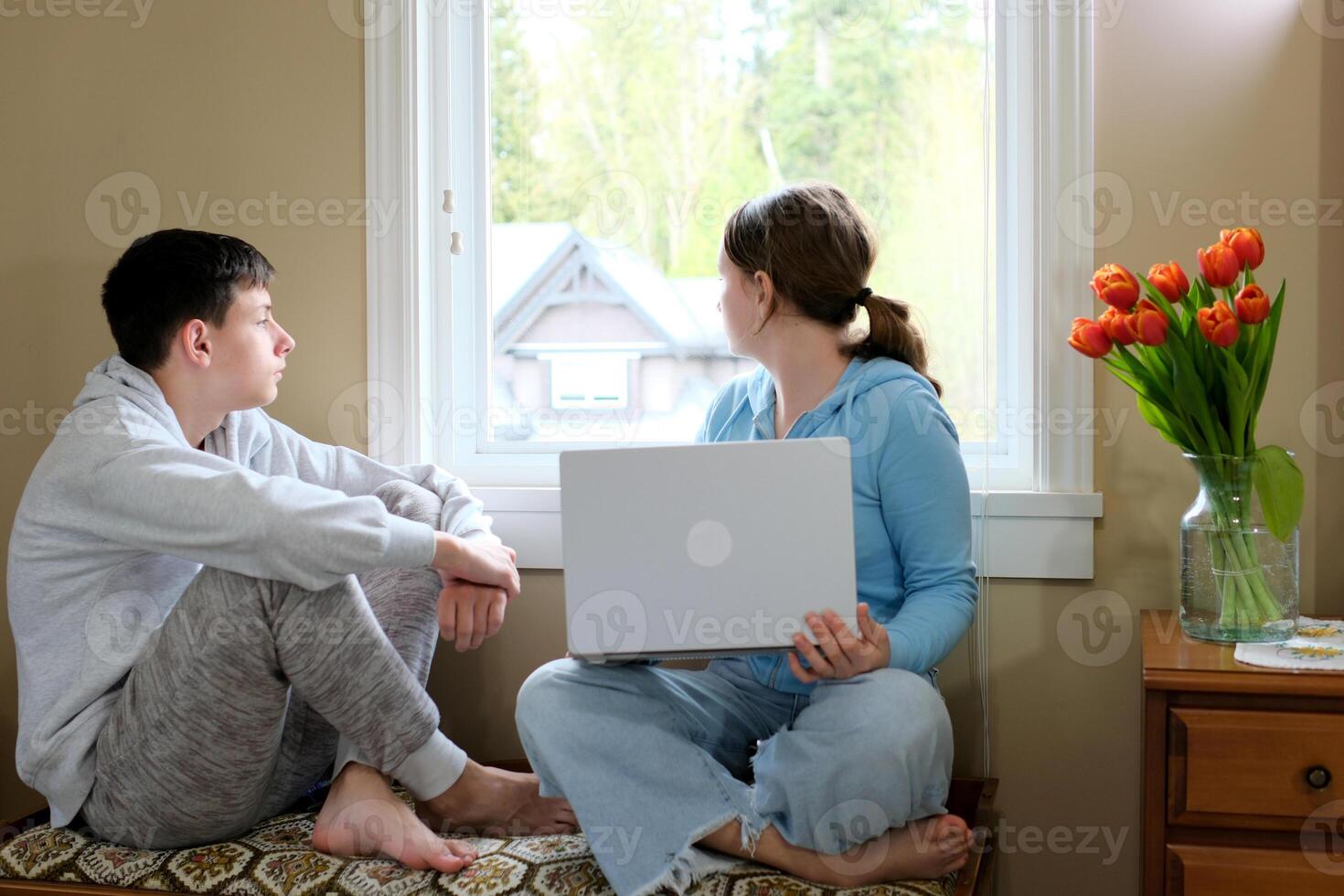children look outside want to walk in their hands laptop need to learn lessons of desire and coercion in room at home good weather outside brother sister friends classmates photo