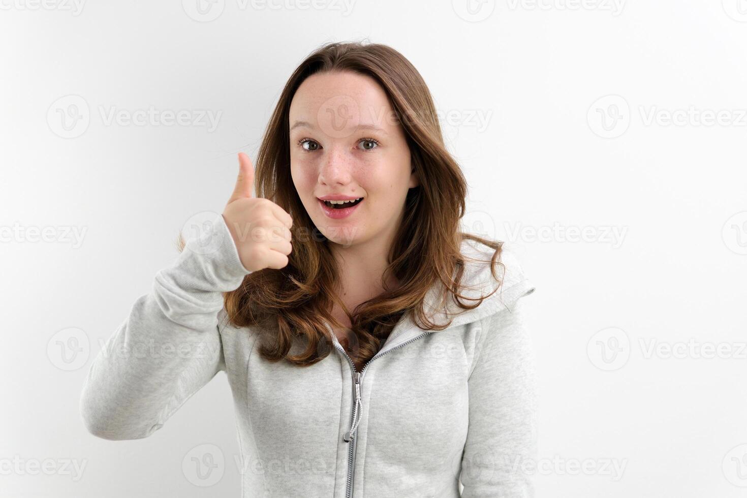 smiling girl in a grey dress on a white background photo