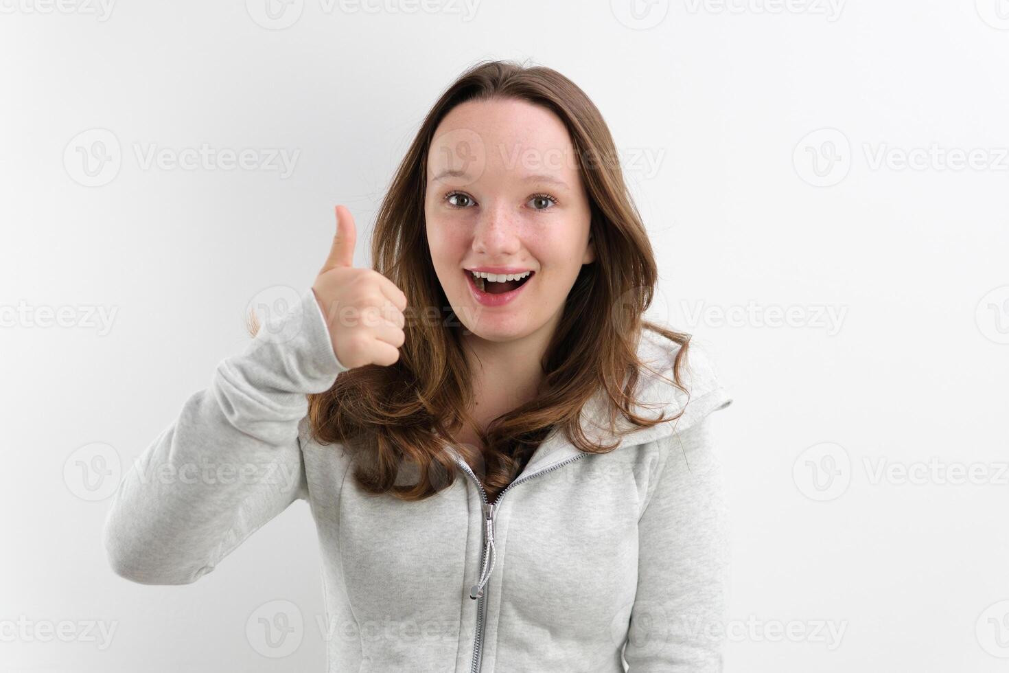 smiling girl in a grey dress on a white background photo