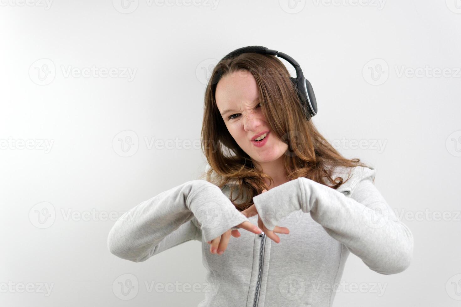 Girl With Headphones Singing and Dancing On White Background photo