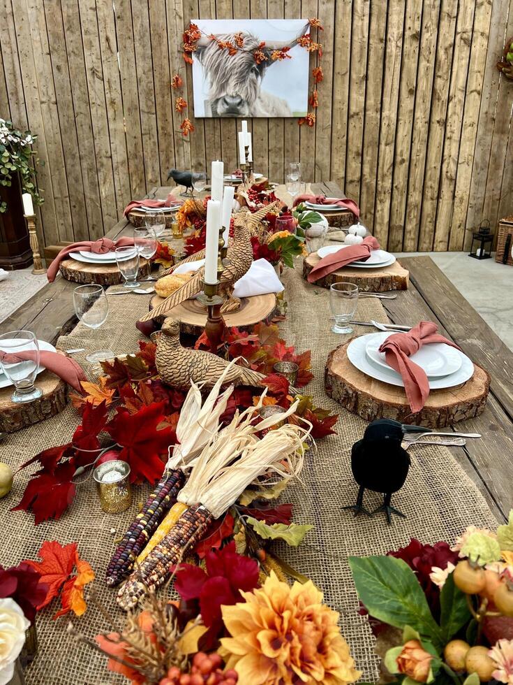 Wooden huge Table massive on which there are devices on wooden stands Mystical mysterious Halloween crows and other golden birds sit on the table Autumn bright orange and yellow flowers dry up photo