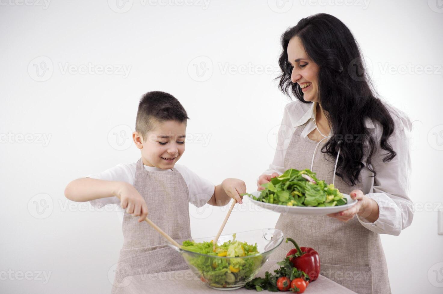 family, cooking and people concept happy mother and little son with molds making cookies from dough at home kitchen photo