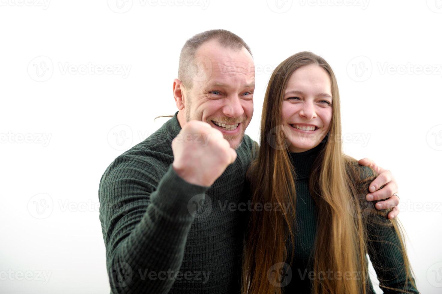 Victory win satisfied faces hugs girl clenched fist with joy shows we won Our victory on white background result of game football match end of project successful business plan hiring in office family photo