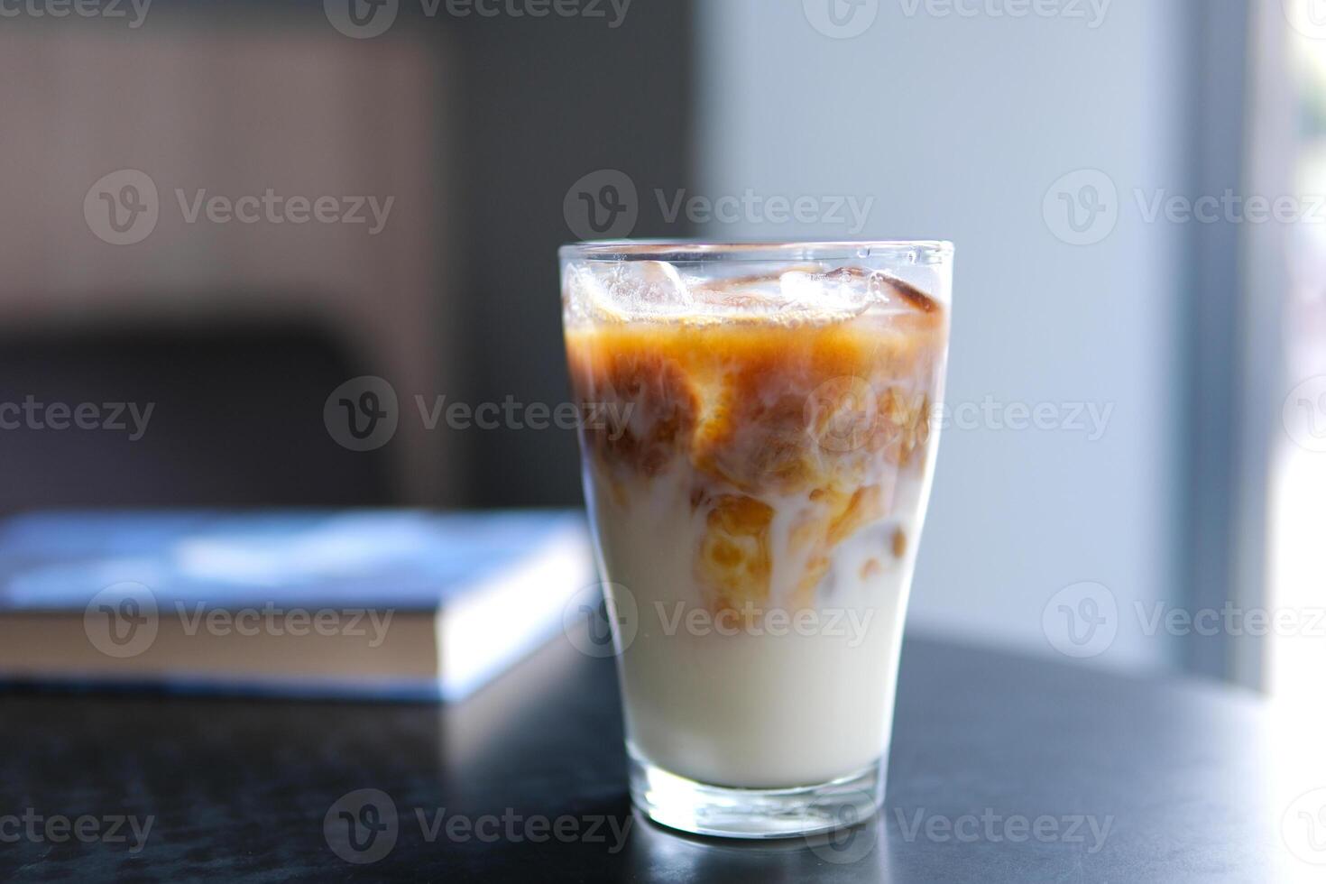 Ice latte with lactose-free milk oat or banana almond coconut milk in a delicious sweet drink close-up macro photography stir add ice several s photo