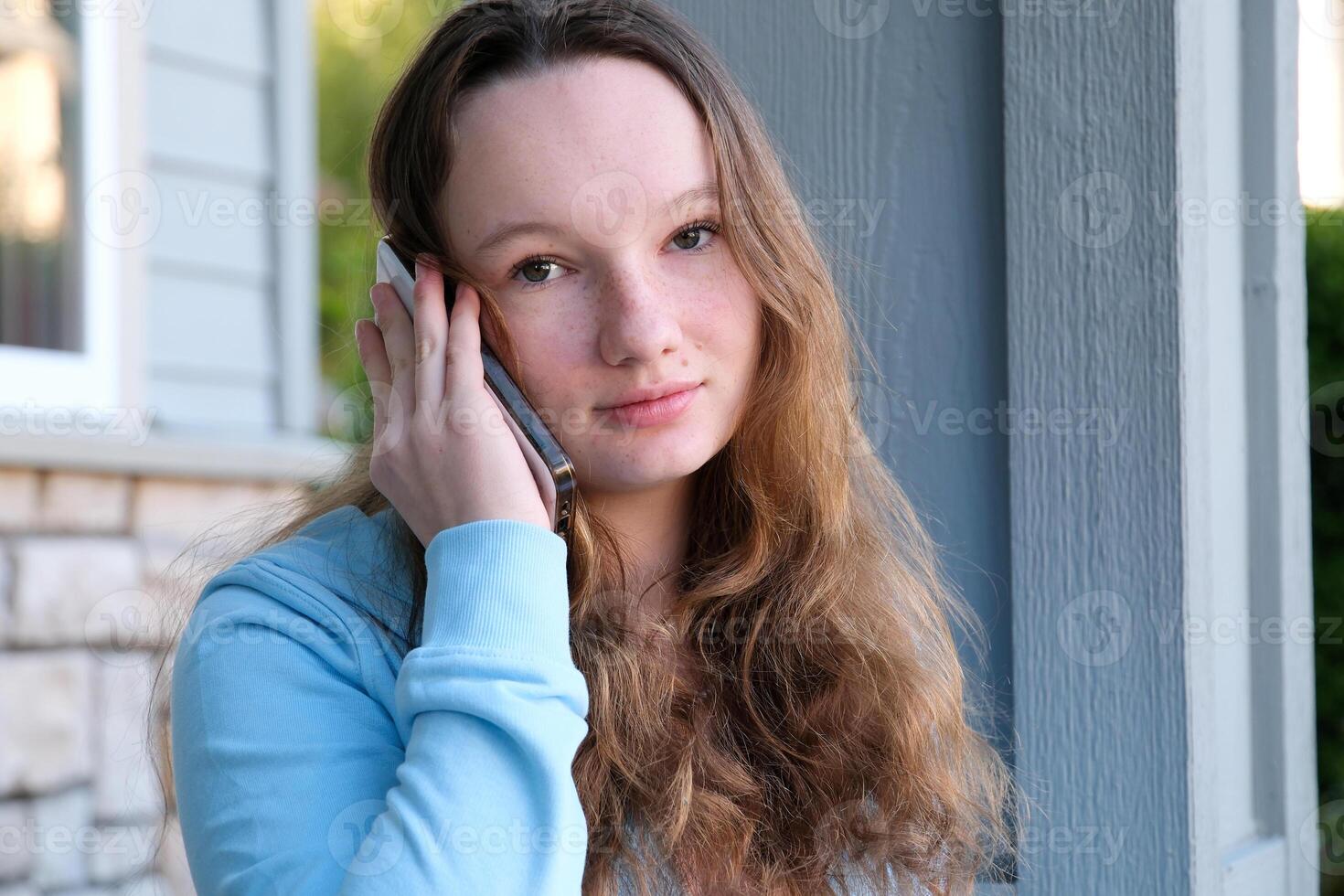 Young middle east student girl smiling happy using smartphone at the city. photo
