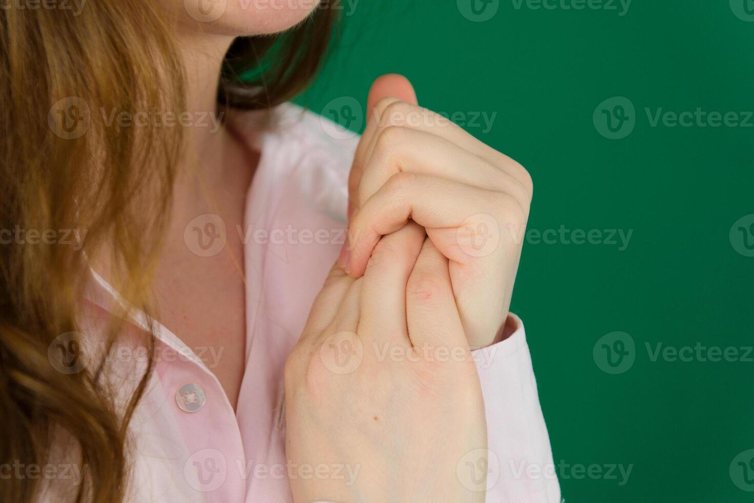 Close up of girl touching wrist feeling hurt joint pain having osteoarthritis disease health problem, woman suffering from pain in hand or wrist, isolated against brown background. Selective focus photo