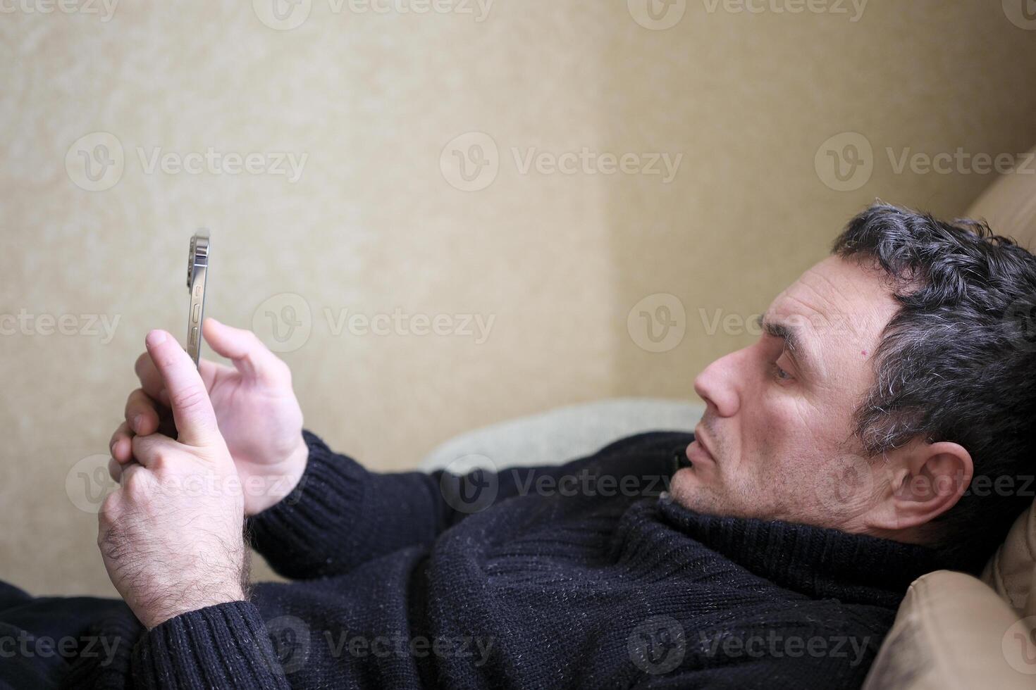 Social media addict men on bed not sleep because play smart phone, room background photo
