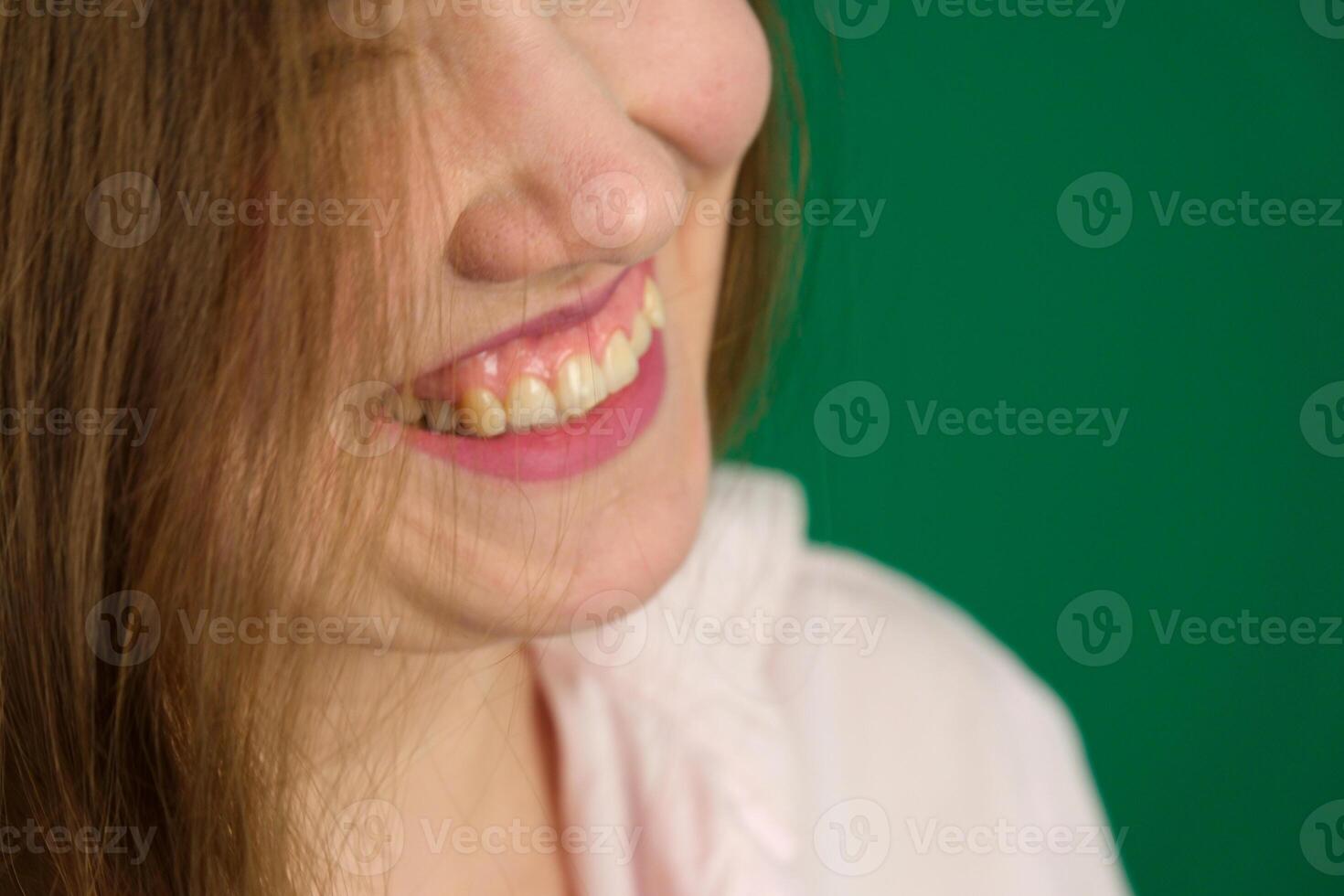 Close up female beauty portrait with Light make-up and clean skin. Young woman smiling and looking aside. photo