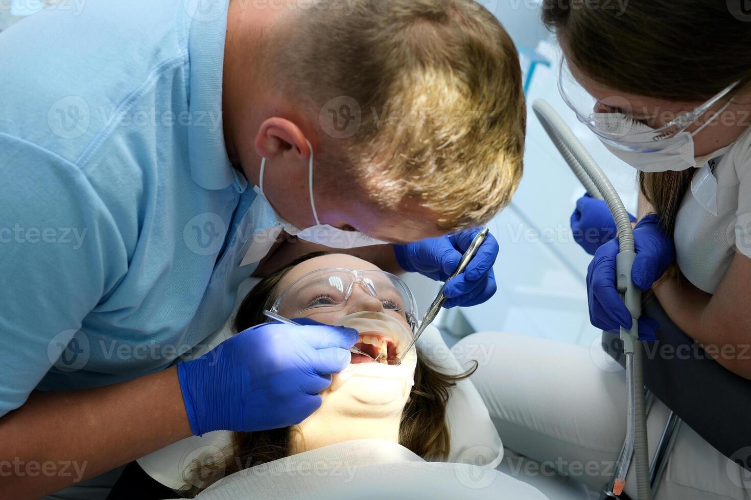 Woman having teeth examined at dentists photo