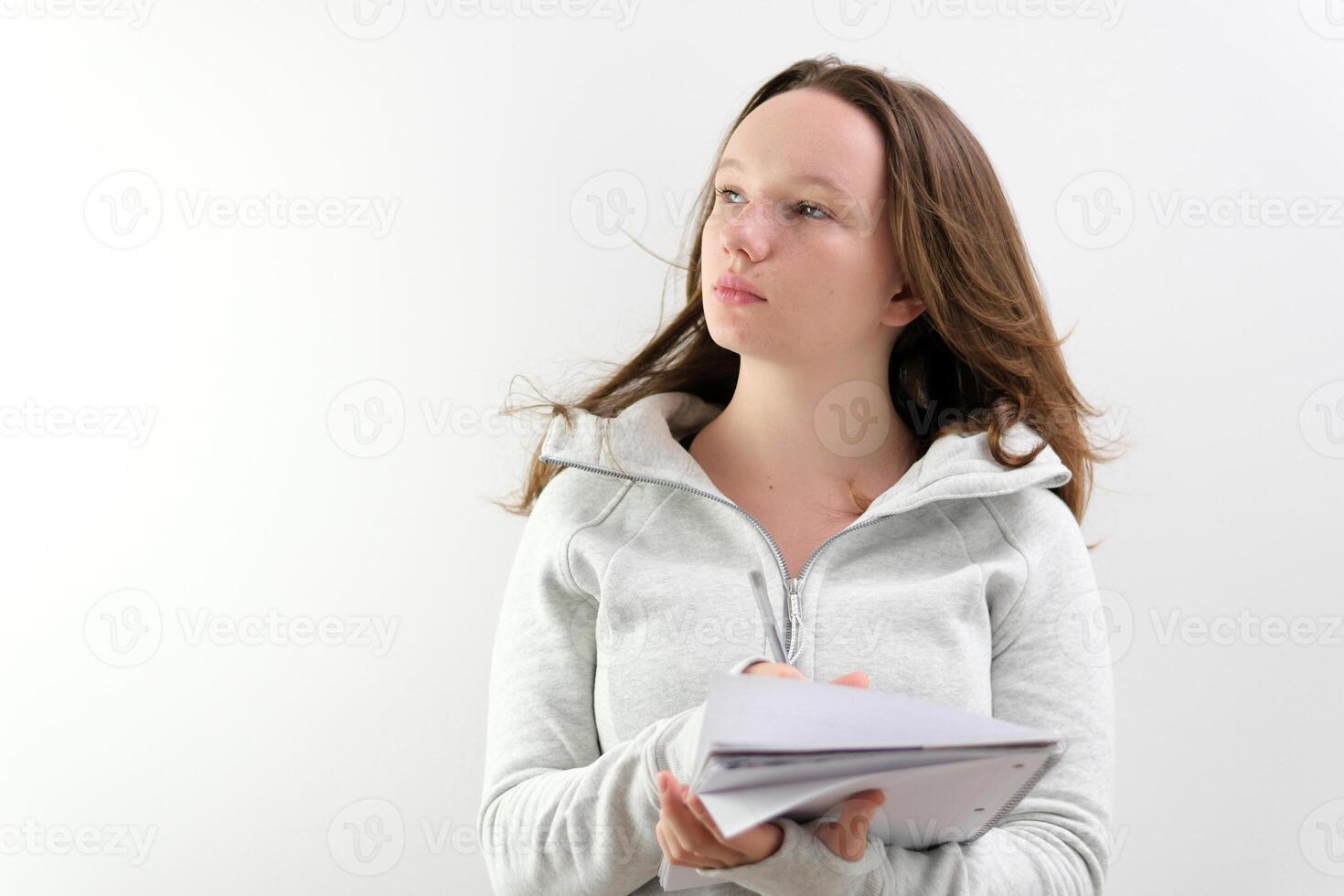 Image of young woman, company worker in glasses, smiling and holding digital tablet, standing over white background photo