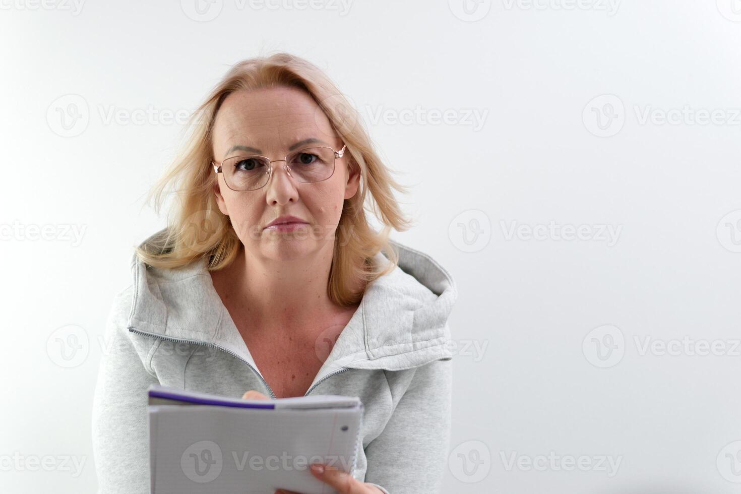 Image of woman, company worker in glasses, smiling and holding digital tablet, standing over white background photo
