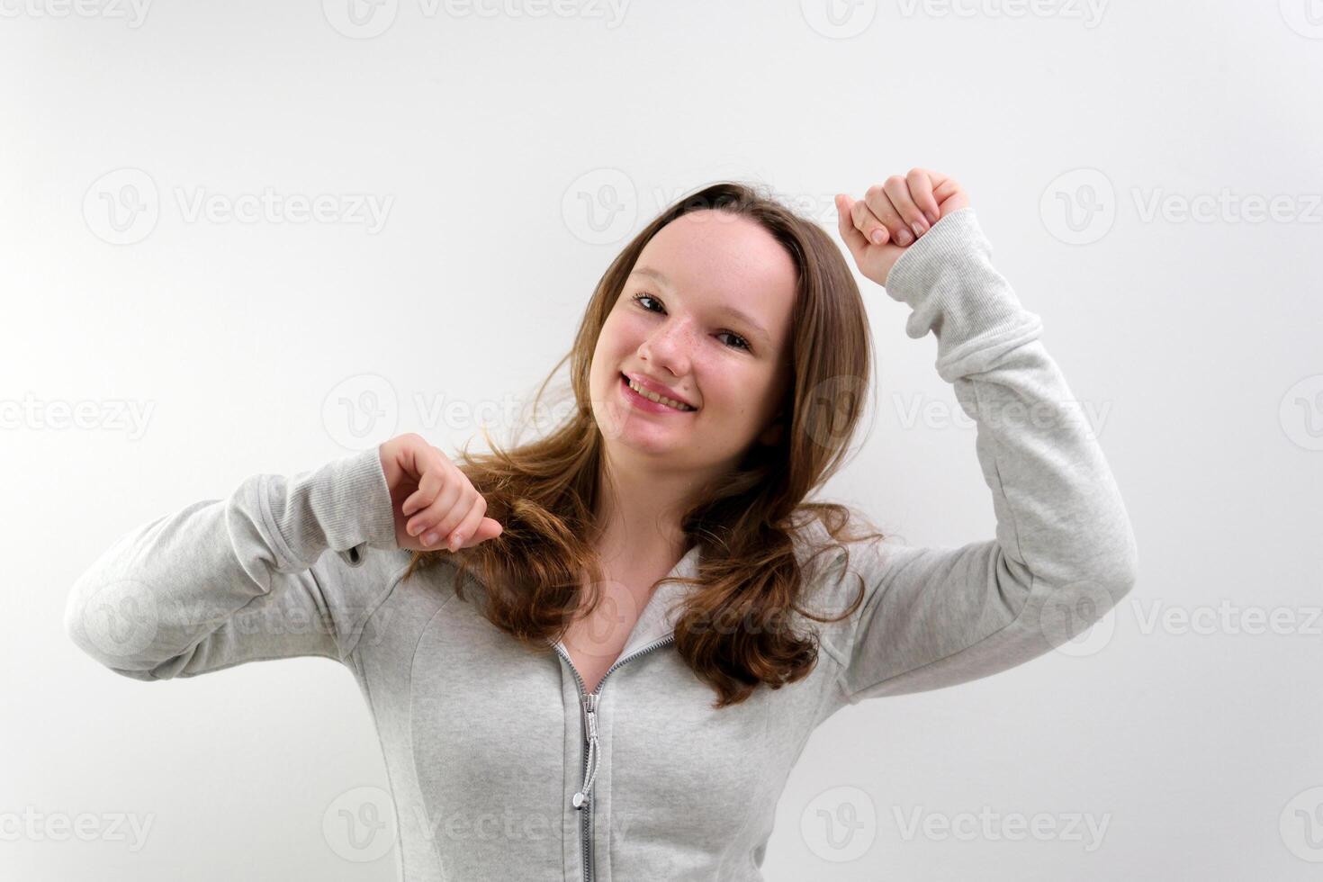 Lovely cheerful young woman greatly approves your suggestion, shaking head approvely, satisfied with good quality work, like proposal, Yes. Pretty one pretty girl isolated on gray studio background photo