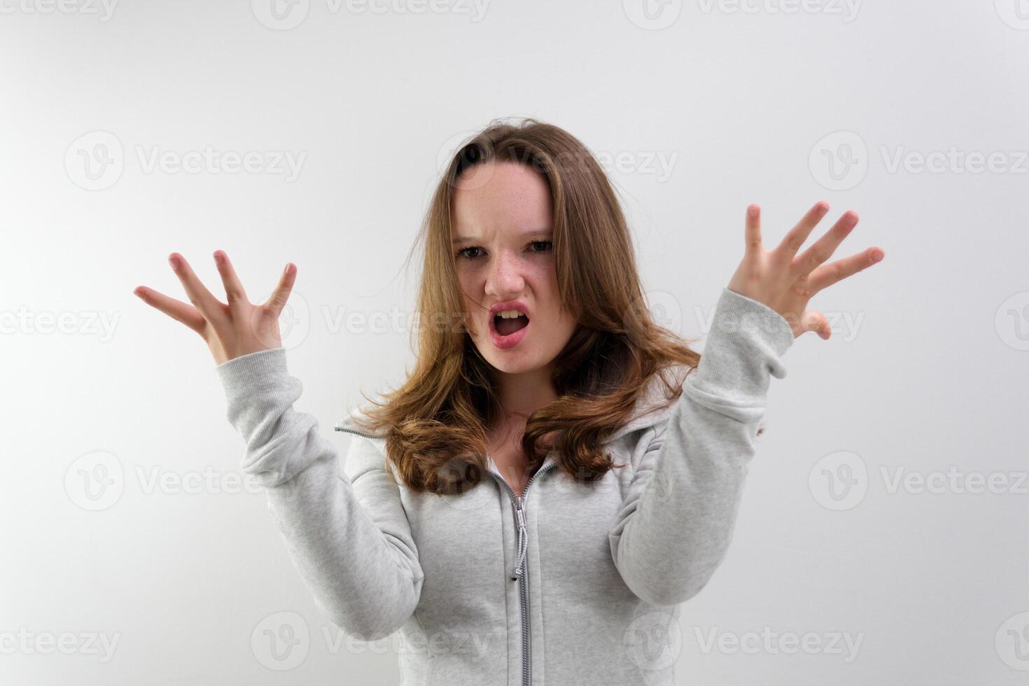 negative emotion of adolescence brain explosion girl with her hands shows how it explodes in her head experiences opens mouth waves hands boom strong explosion on a white background emotional teenager photo