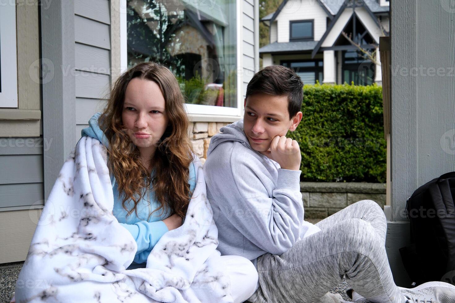 Sad pensive young girl thinking of relationships problems sitting on sofa with offended boyfriend, conflicts in friendship upset couple after fight dispute, making decision of breaking up get divorced photo