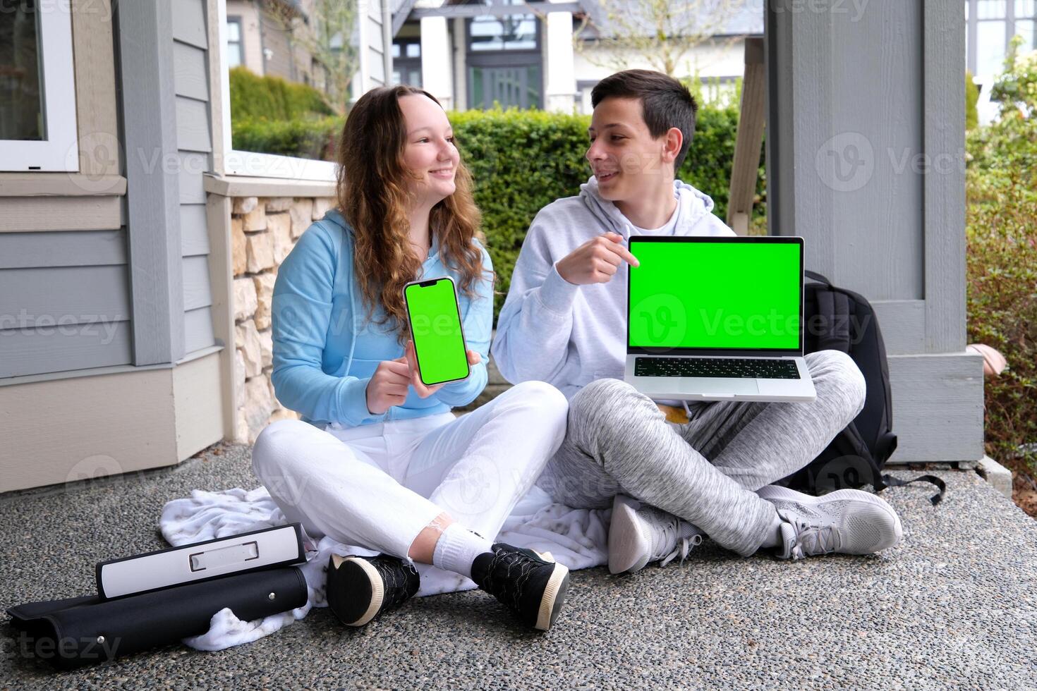 sit on the porch advertising online training sports suit young people communication hold laptop and phone with green screen chromakey laptop sit on porch point finger teen boy teen girl photo