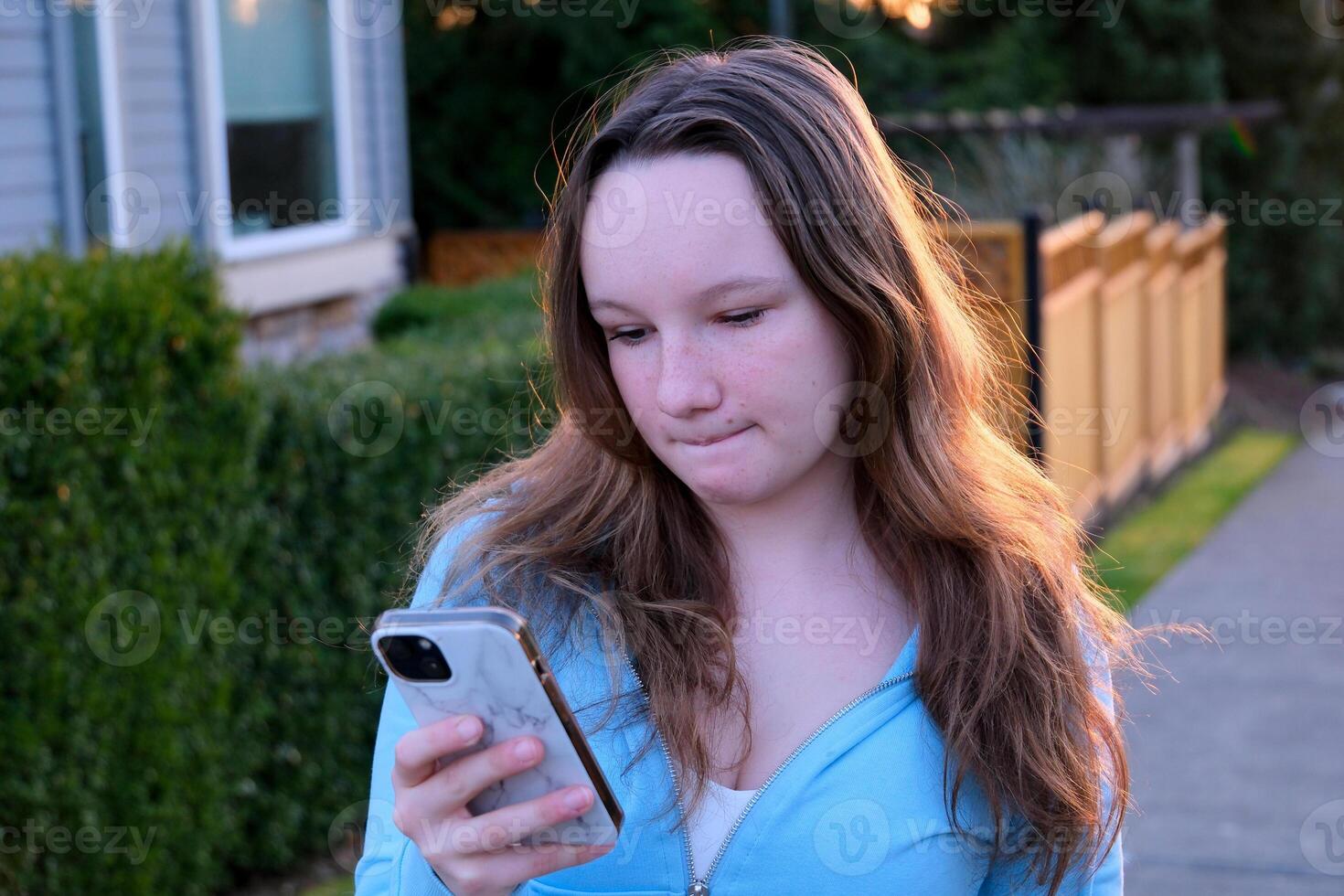 a teenage girl is dissatisfied with something she frowned her eyebrows new message groups social networks internet online being alone with herself adolescence psychological problems of children photo