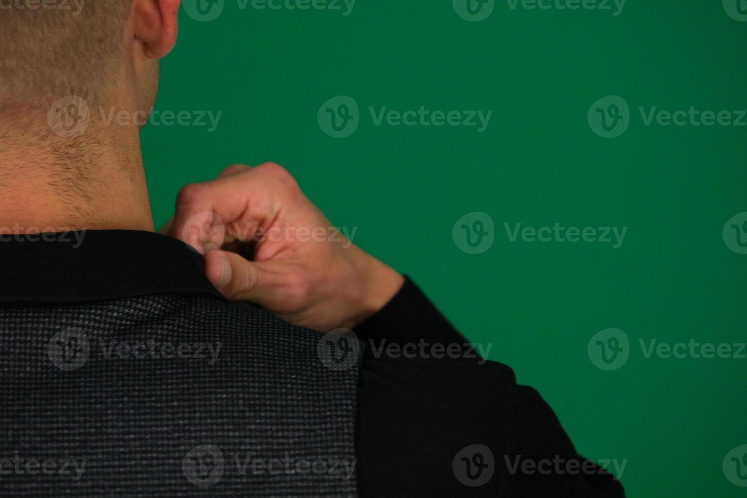close-up of a man's hands straightening a black shirt, he gives us the background of a vest of a classic suit, shoulders from different sides, set Three photos