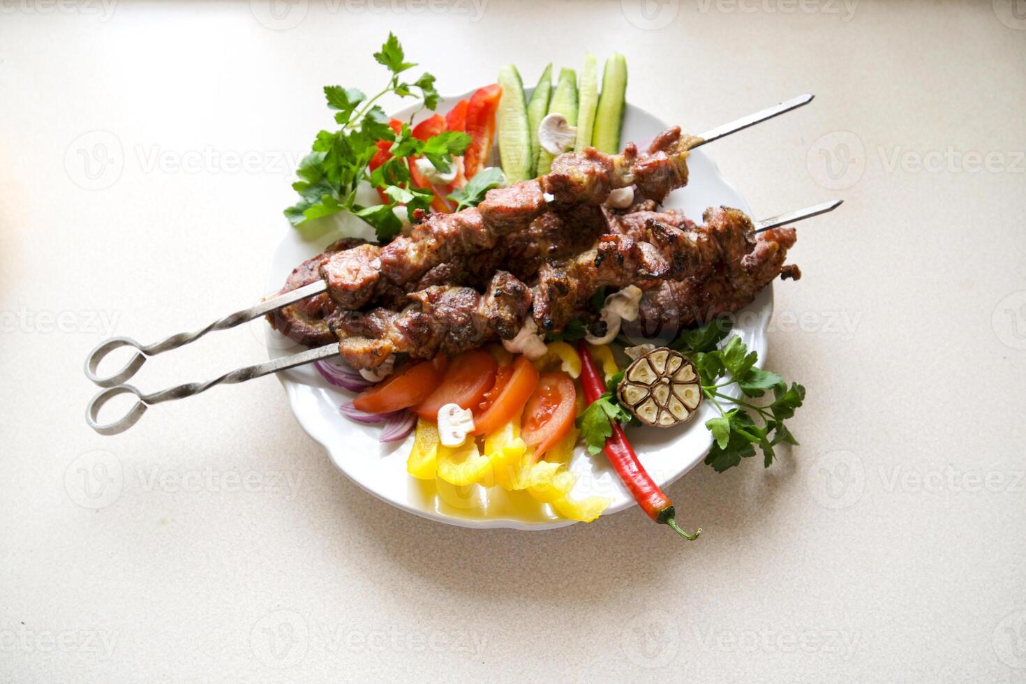 Homemade grilled kebabs of pork with vegetables, served on a slate plate closeup. horizontal photo