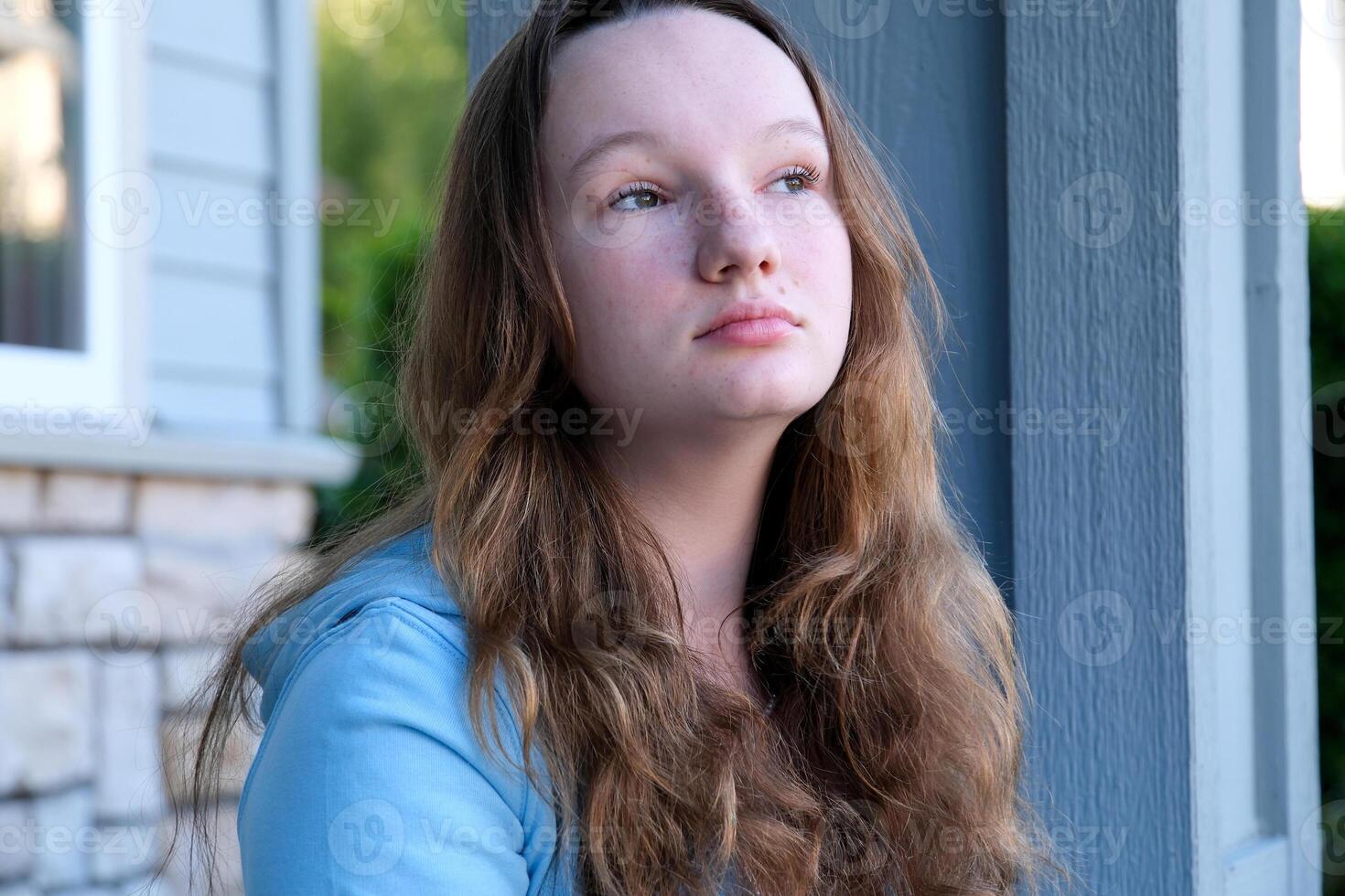draw in an album with a simple pencil A girl sits draws in nature an eraser erases what she wrote looks into the distance and begins to erase the past again to start the future of a new clean slate photo