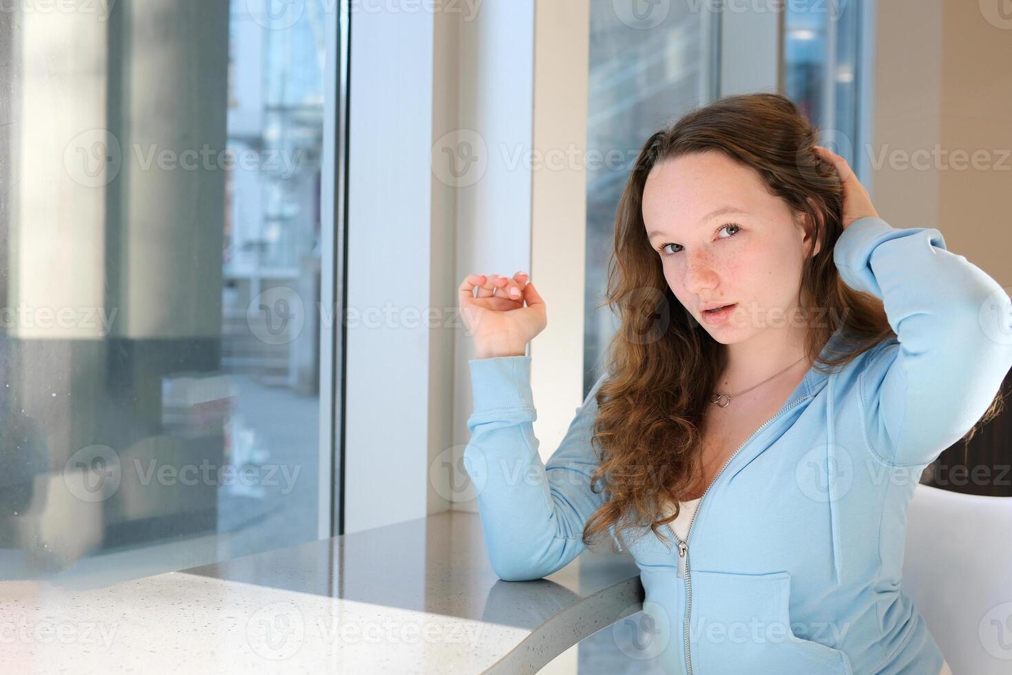 wake up Woman in the morning holding a cup of tea or coffee and looking at the sunrise standing near the window in her home photo