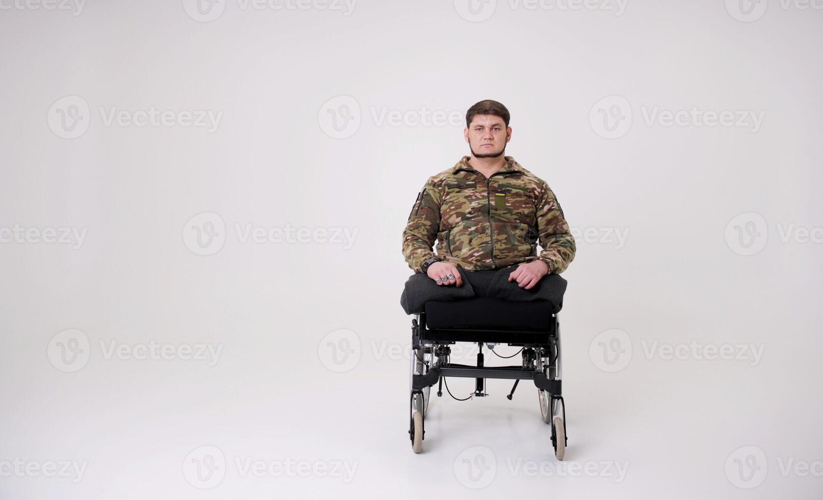 strong military man in a chair without limbs prosthetics photo