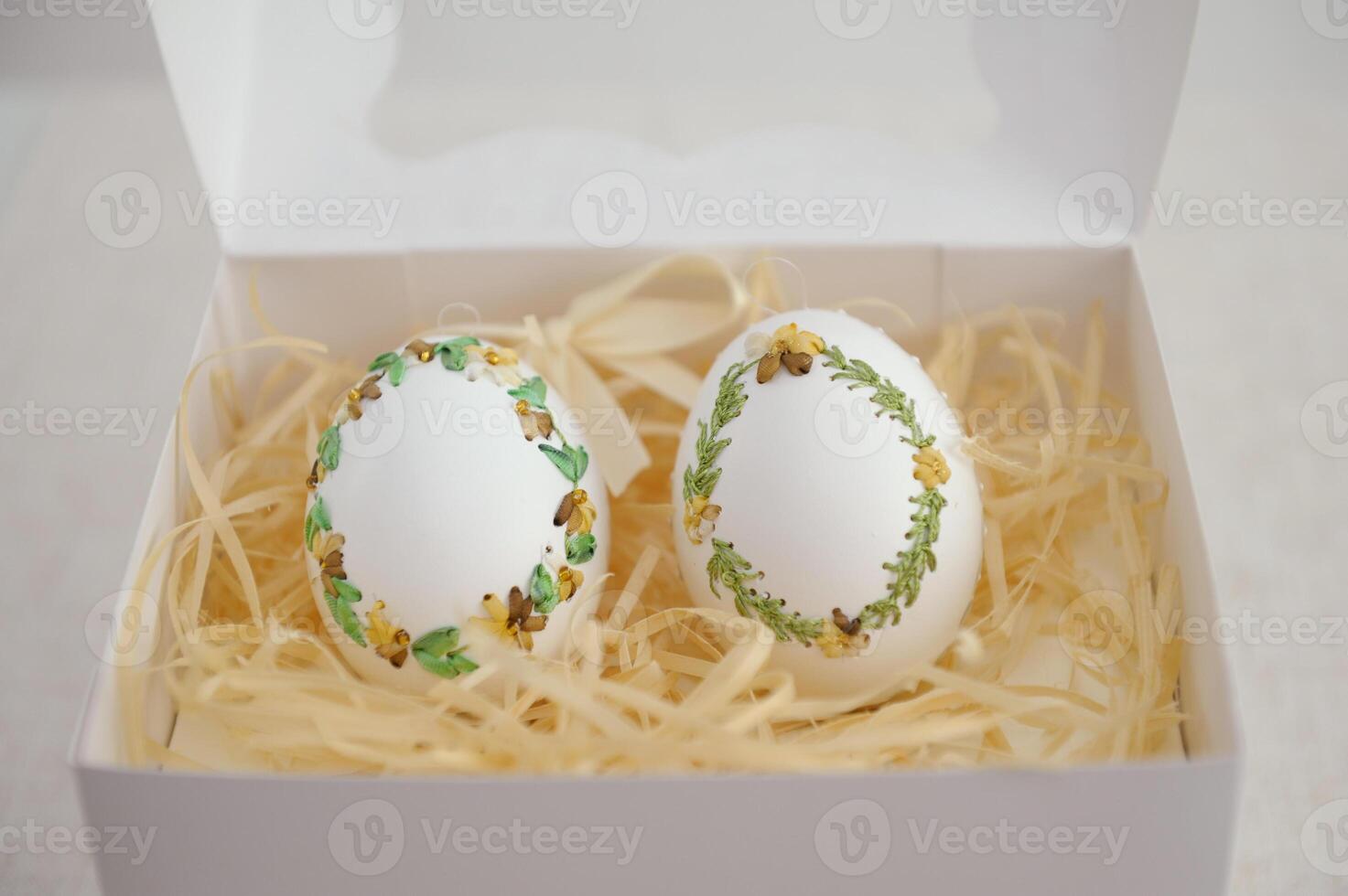 Easter eggs pastel colored in egg box on light background with copy space. Minimal Easter celebration concept, dyed chicken egg with color gradient from blue to beige coloured in carton pack. Top view photo