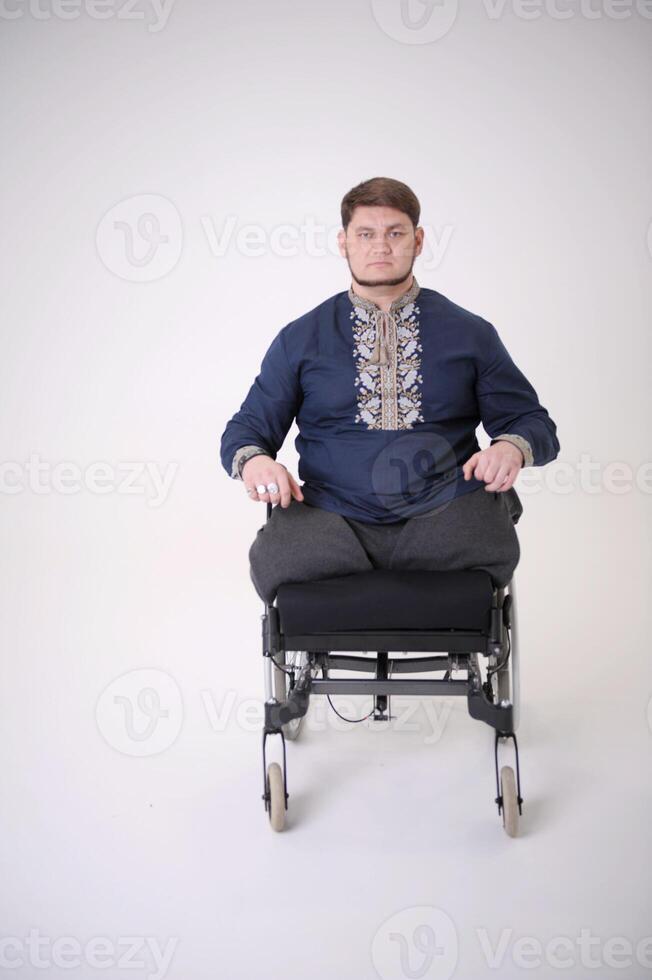 Valya gathered into fist middle-aged man national shirt Patriot hero Ukraine strong-willed face blue shirt on white background social service protection of people affected by violence from war photo