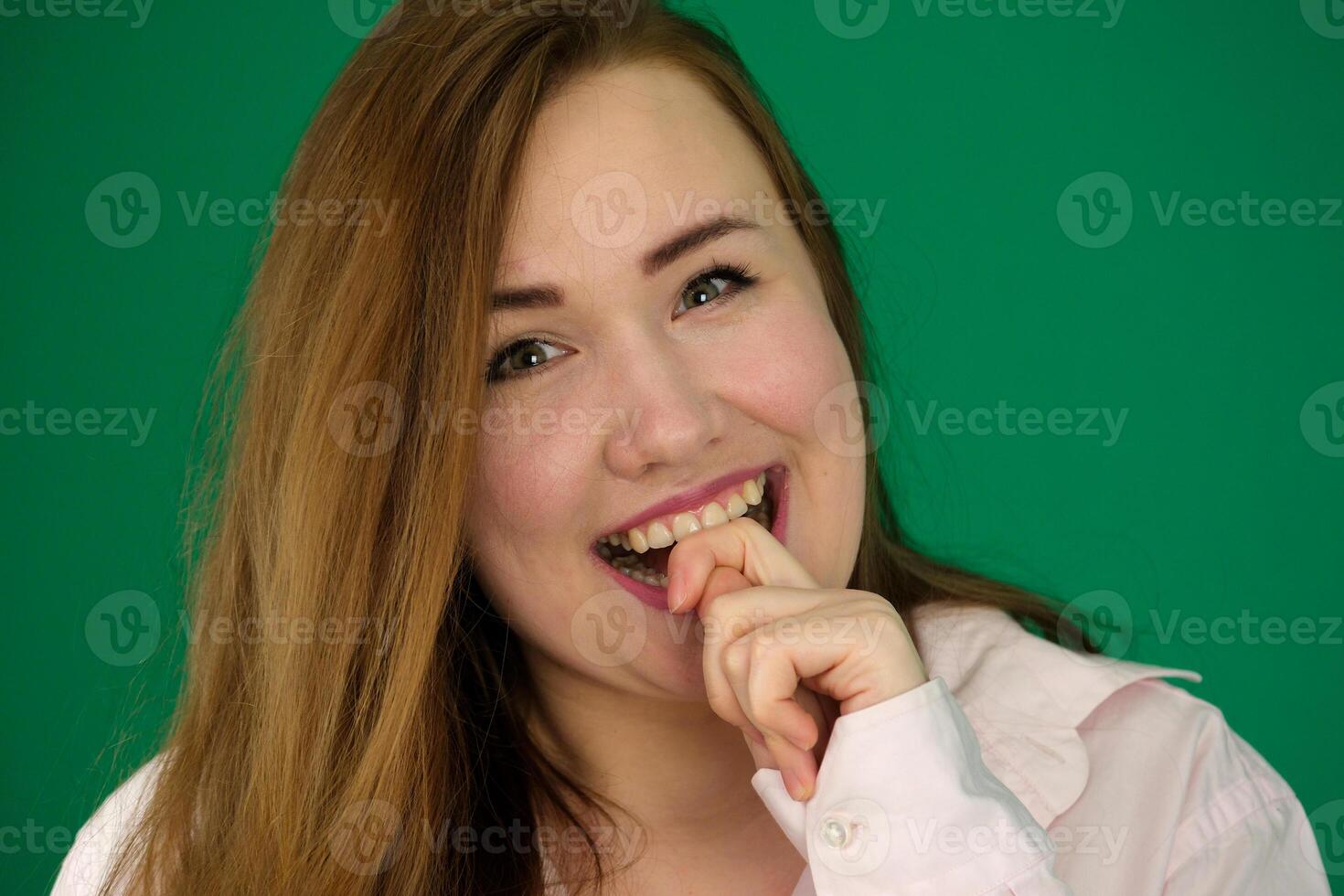 Universal concept of horizontal female portrait on gray alternative background. A photo of a pretty smiling girl with long hair and excellent make-up in a black dress stands in different poses.