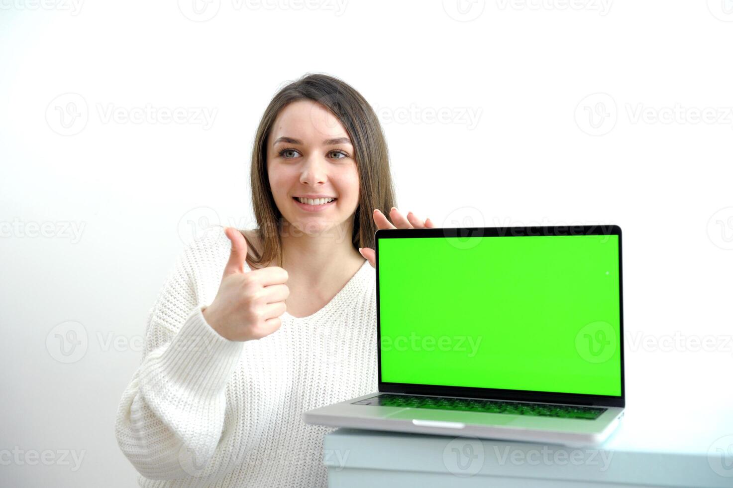 Young business woman sitting on chair with notebook isolated on white photo