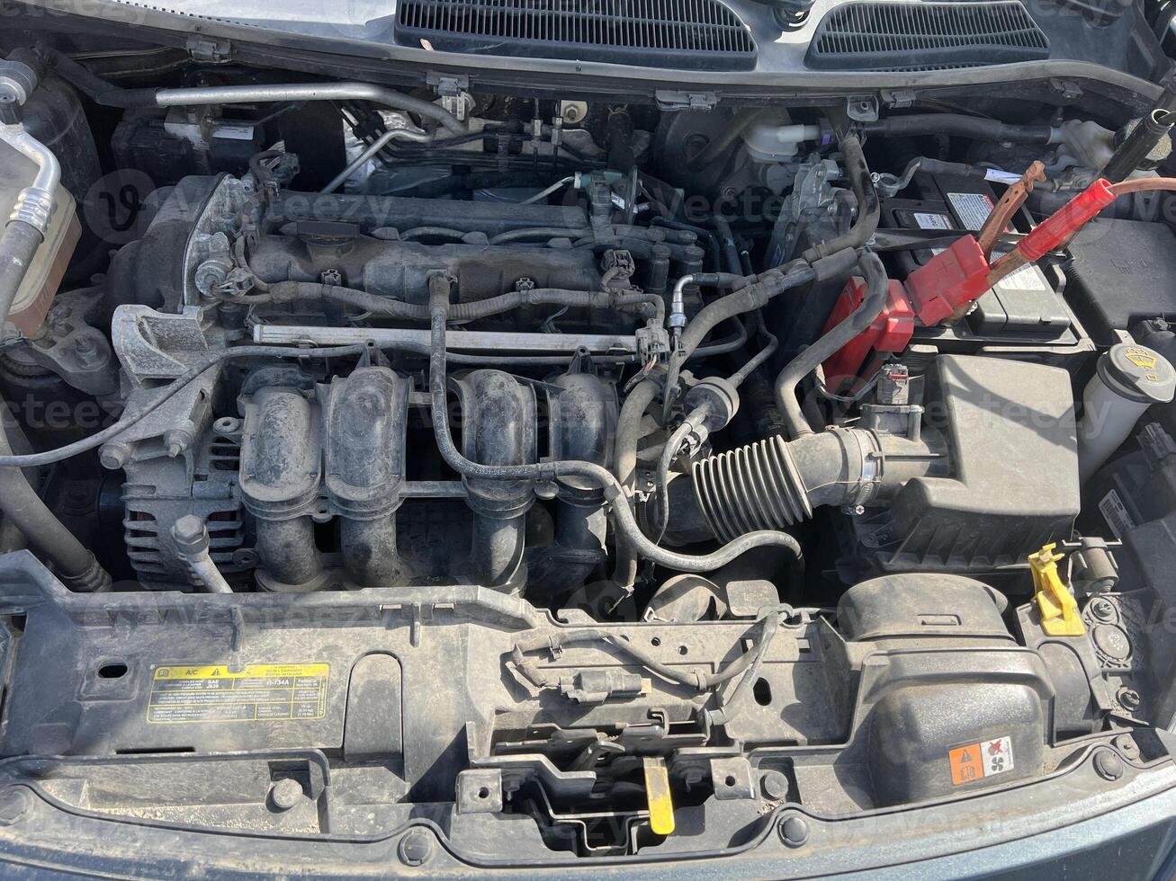 Charging a car battery in winter. Help on the road. Close-up. Connecting high voltage wires to the car battery. Resuscitation of the car in severe winter conditions photo