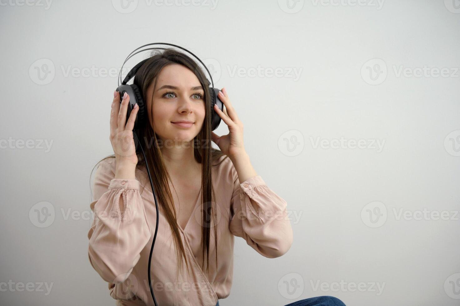 Relaxed young woman enjoying listening to music in wireless earphones, stress free meditation concept. Girl taking a break with audiobook. Horizontal banner with copy space photo
