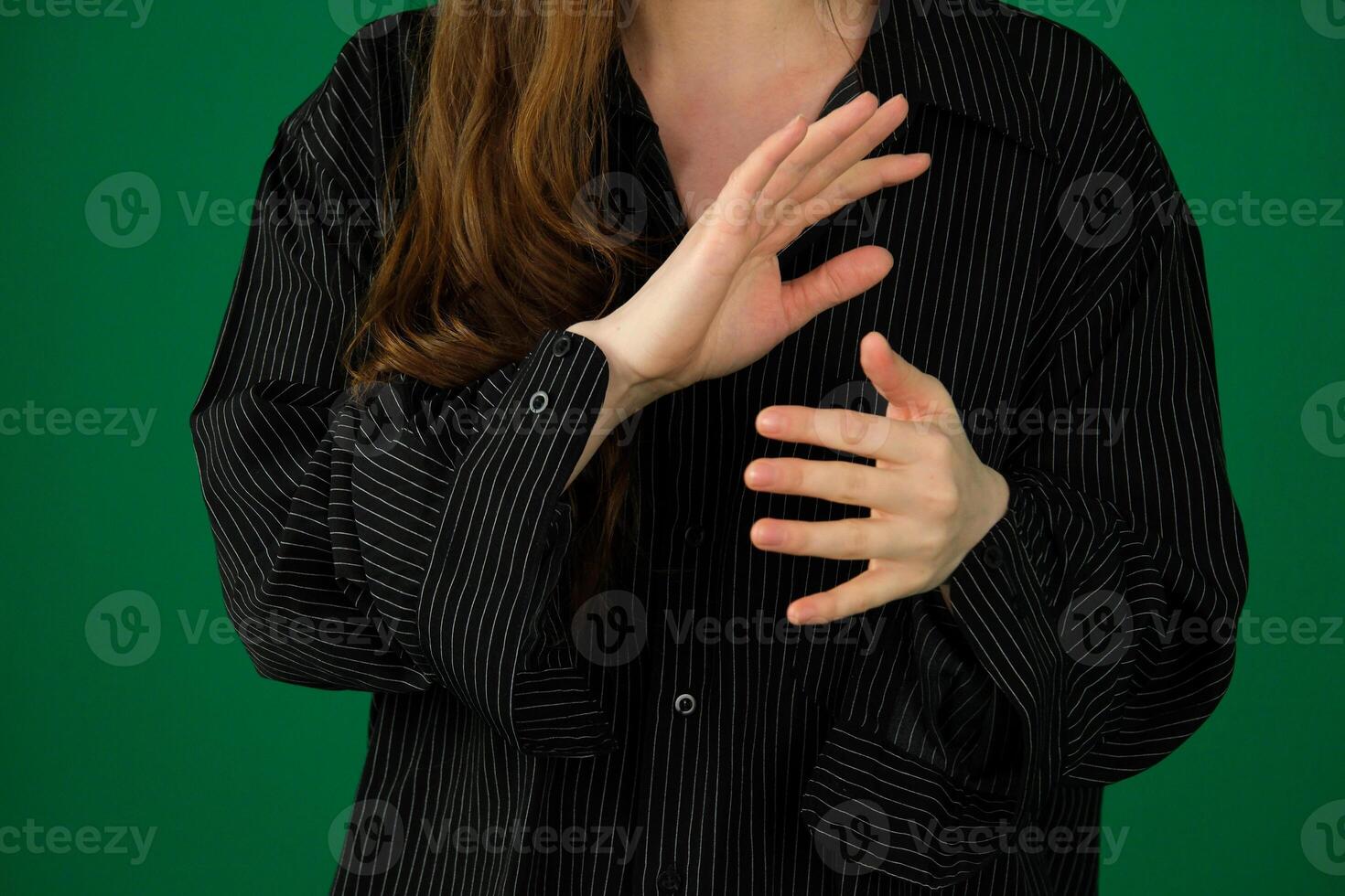 Beautiful woman doing different expressions in different sets of clothes expression of emotions with hands unrecognizable people hands palms fingers close-up on a green background chromakey feelings photo