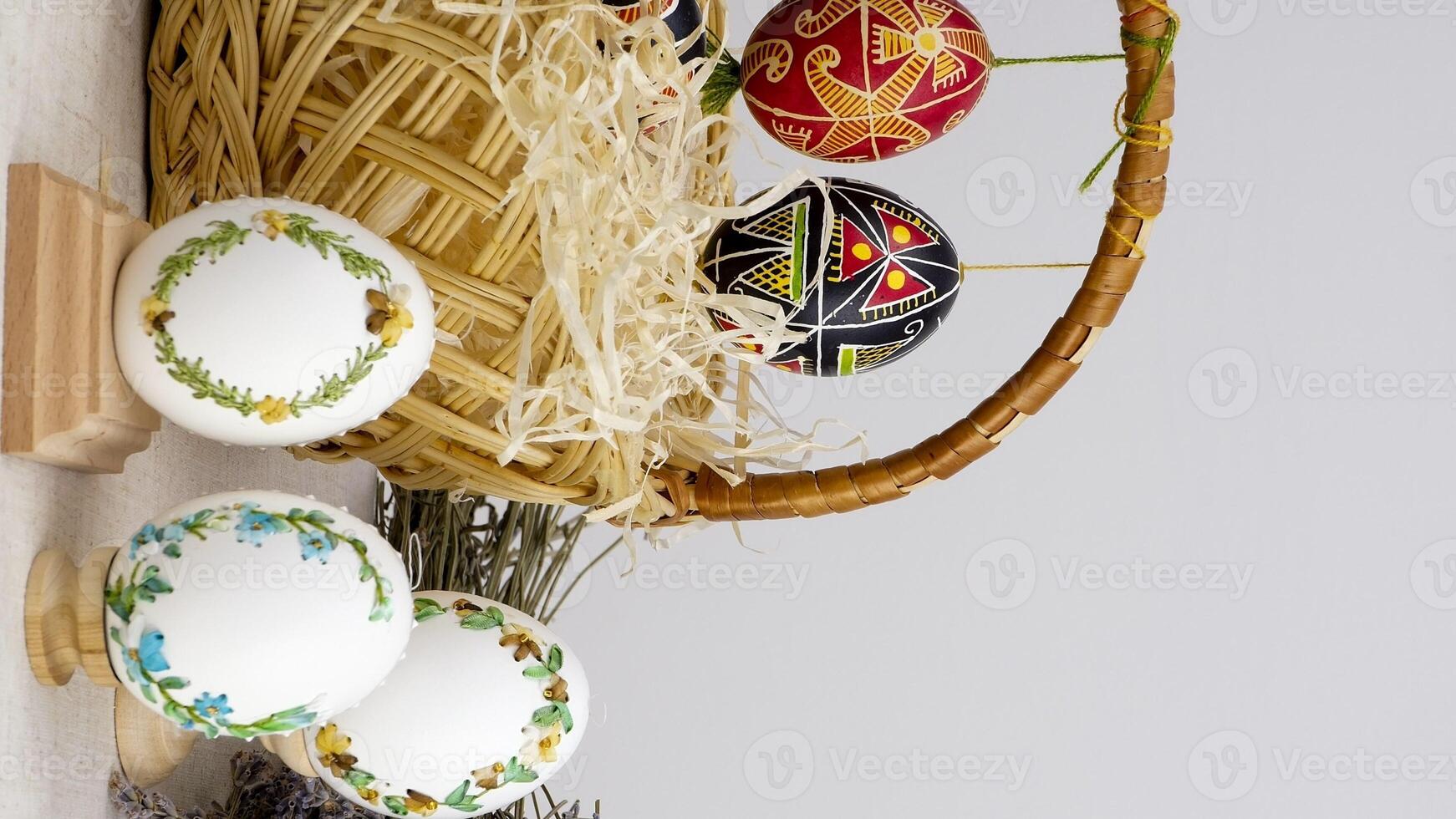 easter composition with phone with white chroma key screen for advertising basket of eggs with embroidery eggs painted lavender flowers wooden coasters on a white background Easter holiday photo