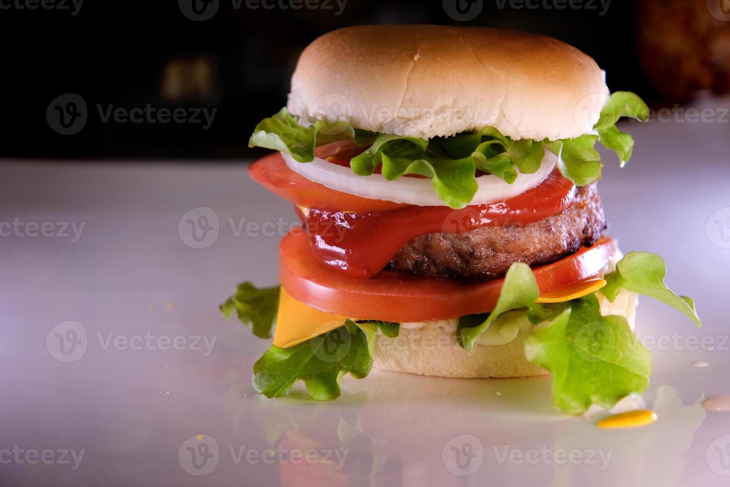 fold a burger create a burger cover with a bun put onion cutlet tomato pour mustard ketchup put cheese and lettuce spread mayonnaise on the bun The whole process in different s photo