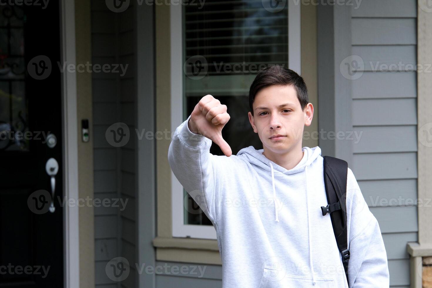 Young hispanic man wearing casual clothes looking unhappy and angry showing rejection and negative with thumbs down gesture. bad expression. photo