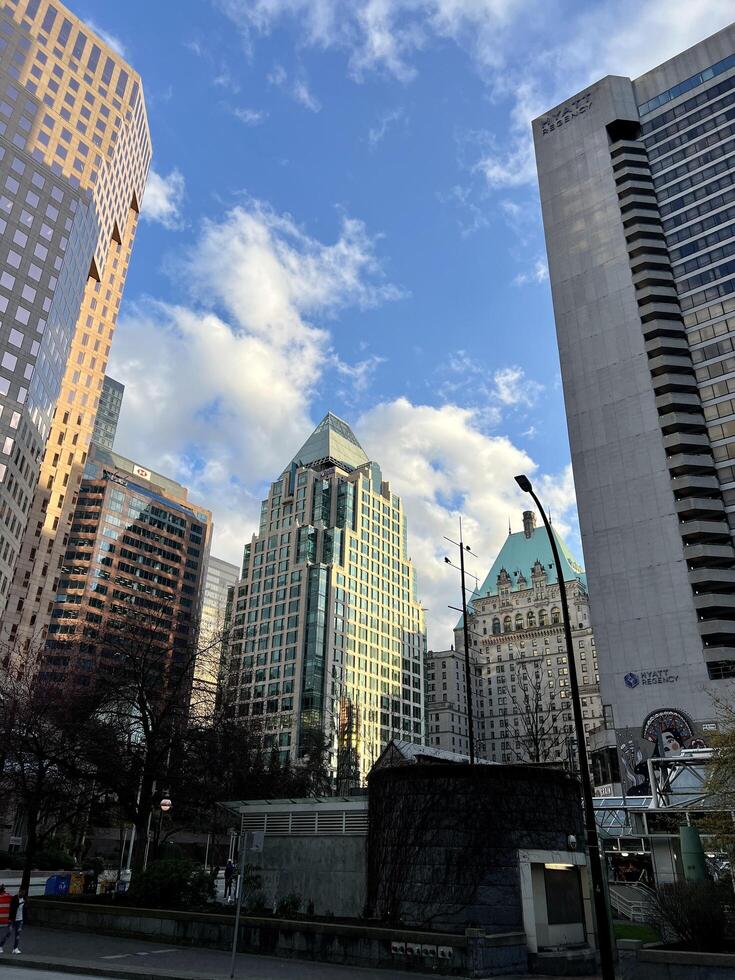 Vancouver Canada 2023 Megapolis is city in world big city life skyscrapers Burrard Skytrain Station houses office road in the city cars traffic morning day evening Real life slow motion news photo