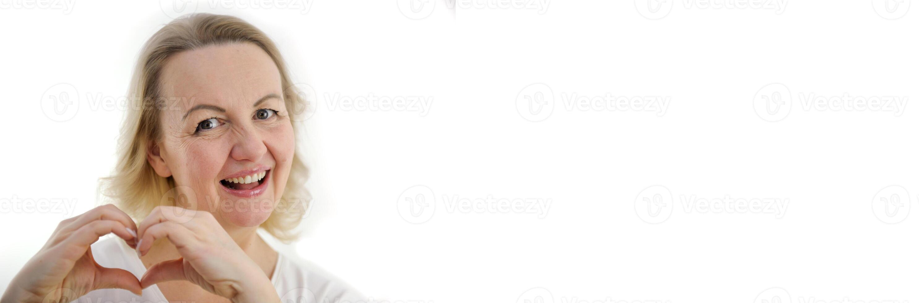 Attractive middle aged woman feeling happy and romantic heart shapes expressing tender feelings Concept of love and care for people banner for advertising white background product on billboard photo