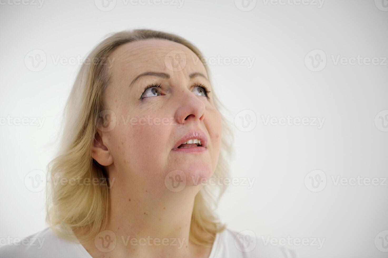 experiencing fear in the eyes of a woman raised her eyes up moved her eyebrows opened her mouth on a white background prayer Communion with God request desires hope photo