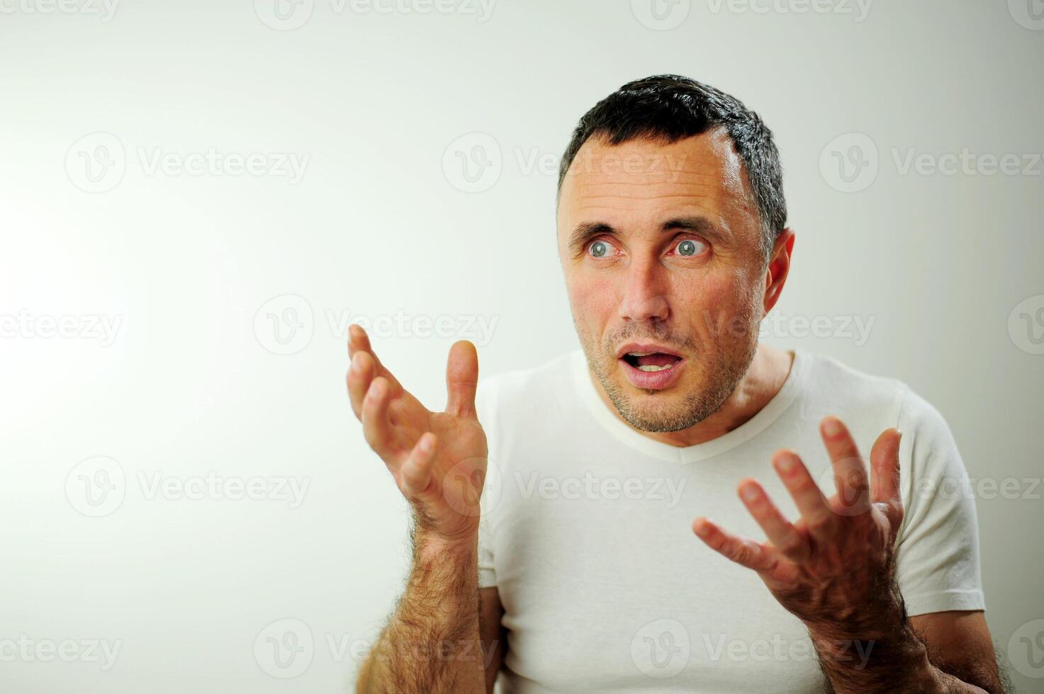 Appalled man emotional guy feeling sinking heart shortness of breath about emotional stress sensations isolated on grey white studio background, frightened person, horror, panic attack concept photo