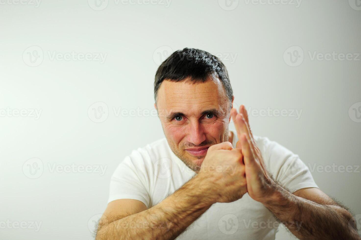 Hit from the left adult man is angry and hits his hand with his fist his hairy strong hands he has black hair and gray Dissatisfaction expressing negative emotions You will get what you deserve photo