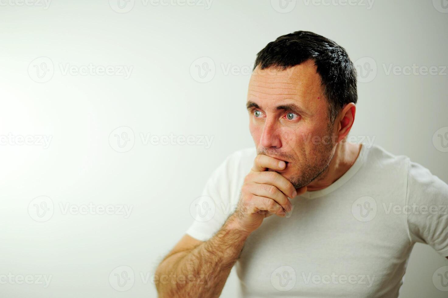 Appalled man emotional guy feeling sinking heart shortness of breath about emotional stress sensations isolated on grey white studio background, frightened person, horror, panic attack concept photo